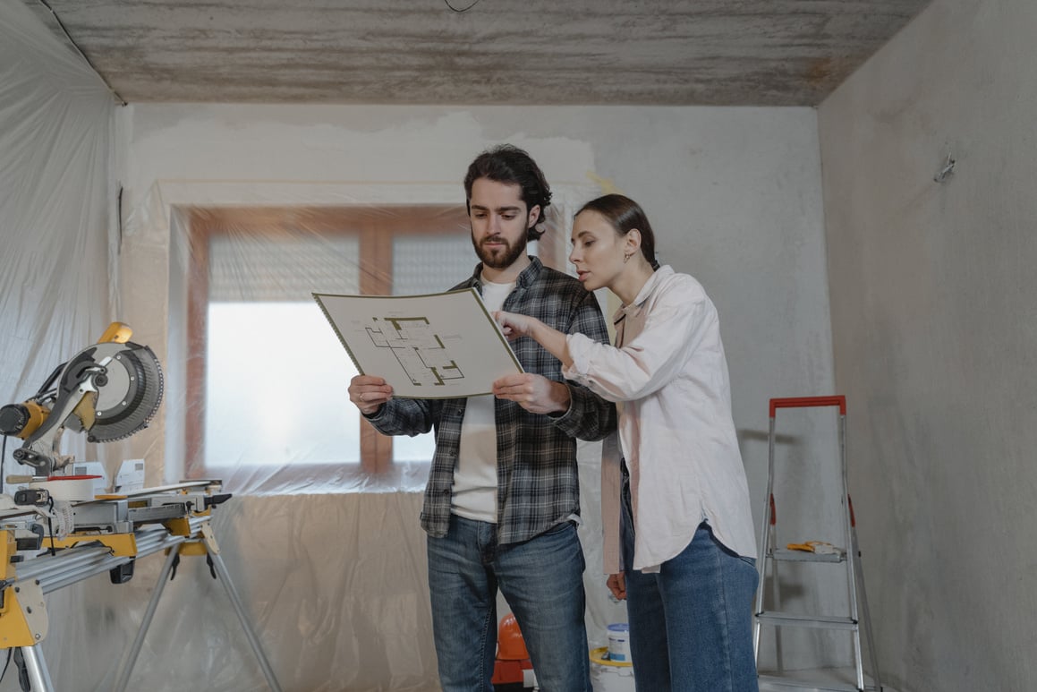 Man and Woman Holding White Paper